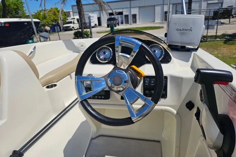Slide: The Image of 2019 Stingray 182 SC boat dashboard with Garmin GPS and modern steering wheel. - 22