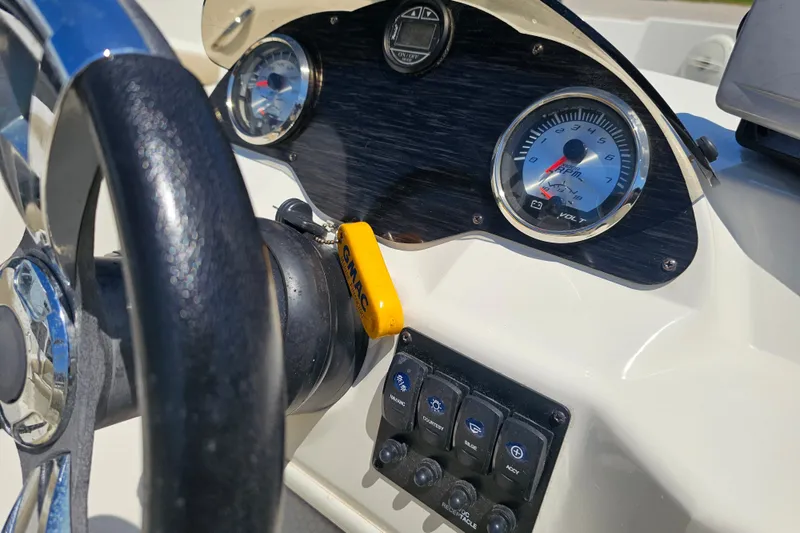 Slide: The Image of Dashboard of a 2019 Stingray 182 SC boat with steering wheel and gauges. - 23