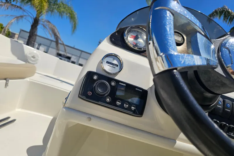 Slide: The Image of 2019 Stingray 182 SC boat dashboard with steering wheel and control panel. - 24