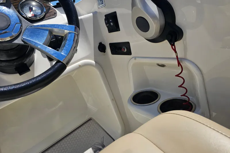 Slide: The Image of 2019 Stingray 182 SC boat interior with steering wheel, controls, and cup holders. - 27