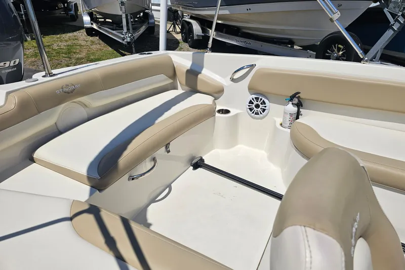 Slide: The Image of 2019 Stingray 182 SC boat interior with beige seating and safety equipment. - 28