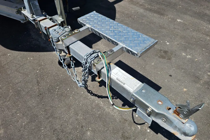 Slide: The Image of Trailer hitch of a 2019 Stingray 182 SC boat, featuring safety chains and wiring. - 5