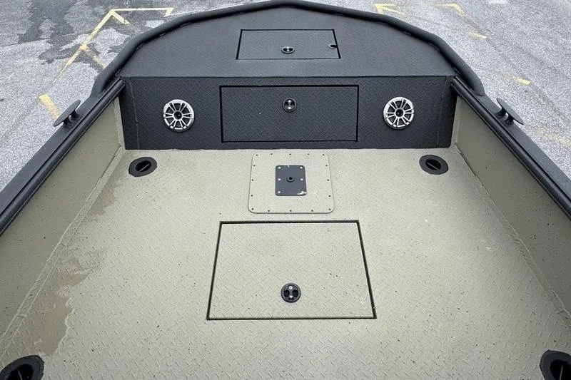 Slide: The Image of 2026 SeaArk Predator 300 AK boat deck with storage compartments and speakers. - 10