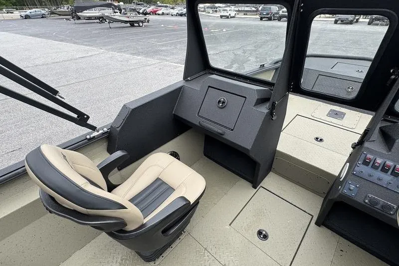 Slide: The Image of Interior of 2026 SeaArk Predator 300 AK boat, featuring a comfortable captain's chair and control panel. - 11