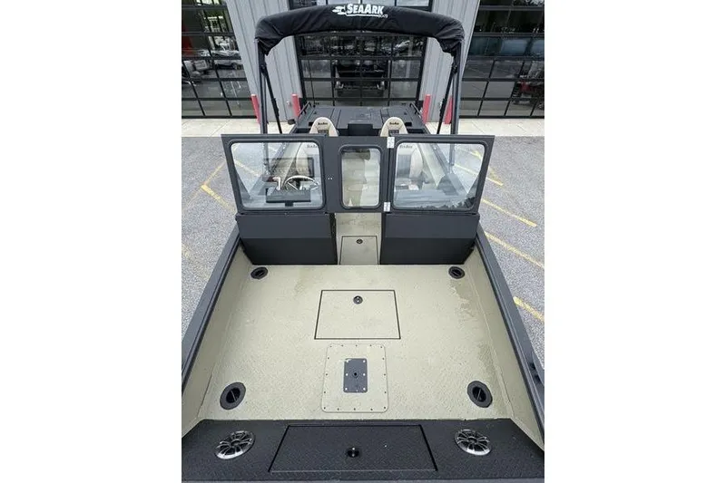 Slide: The Image of 2026 SeaArk Predator 300 AK boat interior with spacious deck and windshield view. - 14