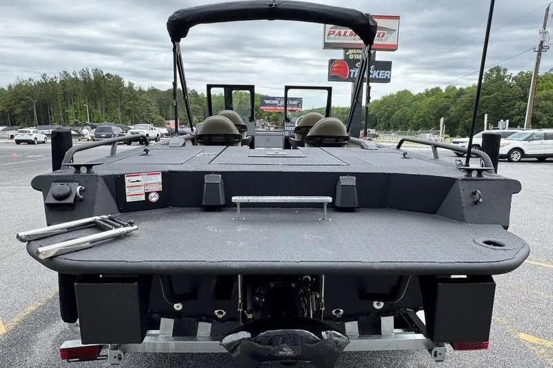 Slide: The Image of 2026 SeaArk Predator 300 AK boat, rear view, parked outdoors on a cloudy day. - 4