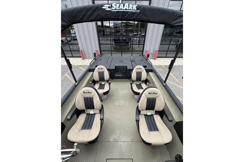 Slide: The Image of 2026 SeaArk Predator 300 AK boat interior with four beige and black seats. - 9