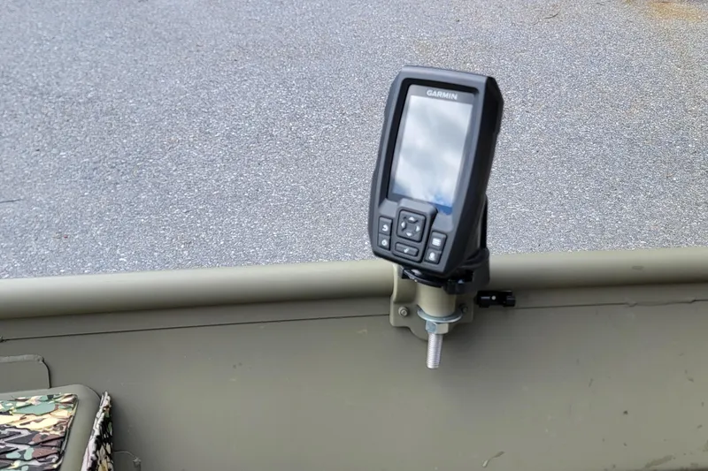 Slide: The Image of Fishfinder mounted on a 2025 Tracker Grizzly 12 Jon boat, showing control buttons. - 3