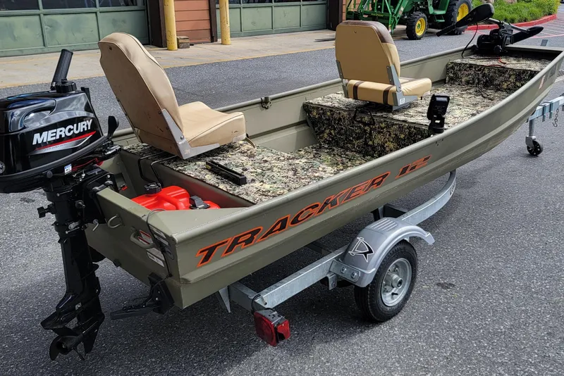 Slide: The Image of 2025 Tracker Grizzly 12 Jon boat with Mercury motor on a trailer. - 9