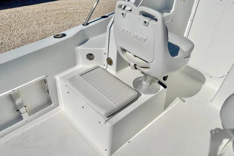 Slide: The Image of 2005 Sea Pro 220 Walk Around boat interior with seating and helm chair. - 12