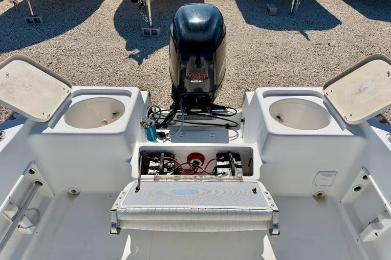 Slide: The Image of 2005 Sea Pro 220 Walk Around boat with Suzuki 225 engine and open storage compartments. - 13