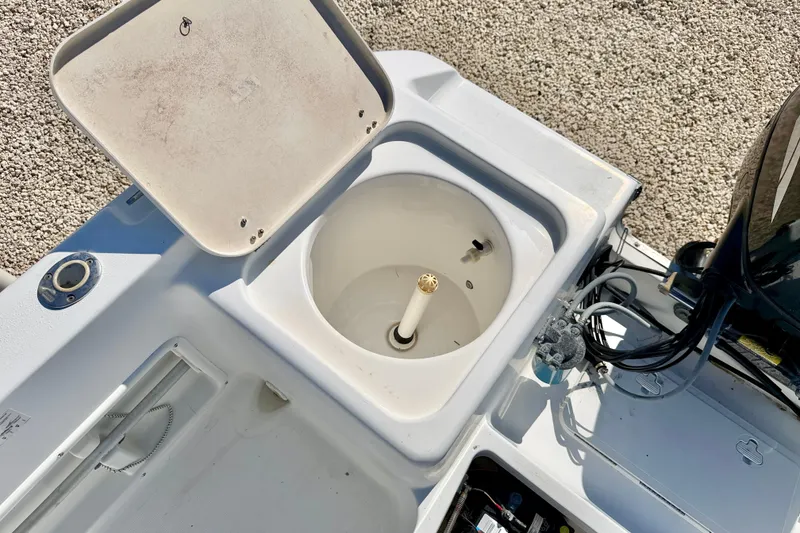 Slide: The Image of 2005 Sea Pro 220 Walk Around boat's open storage compartment and engine area. - 14