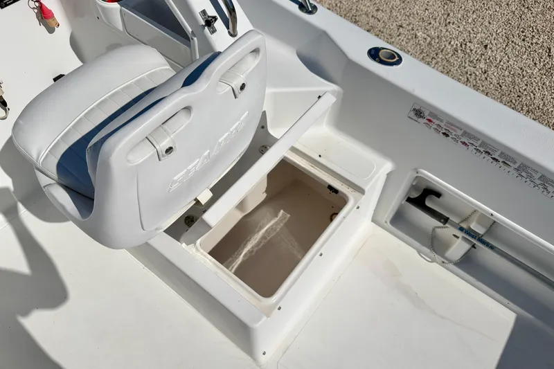 Slide: The Image of 2005 Sea Pro 220 Walk Around boat interior with storage compartment and seating. - 17
