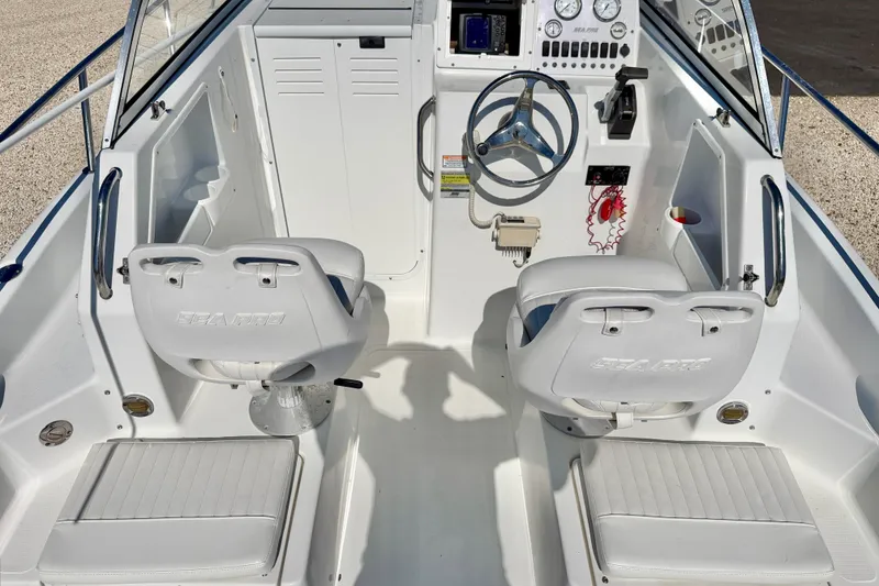 Slide: The Image of 2005 Sea Pro 220 Walk Around boat interior with dual seats and steering console. - 18