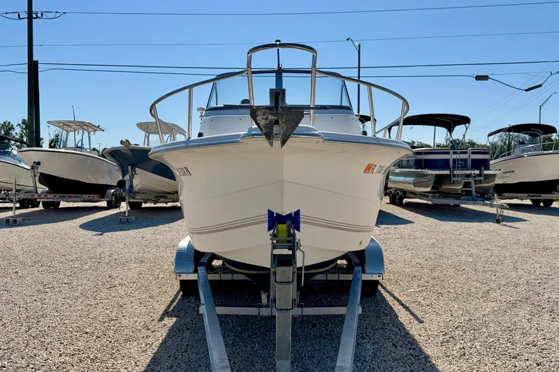 Slide: The Image of 2005 Sea Pro 220 Walk Around boat on trailer in a marina setting. - 2