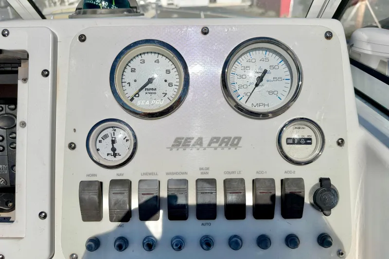 Slide: The Image of Dashboard of 2005 Sea Pro 220 Walk Around boat with gauges and switches. - 21