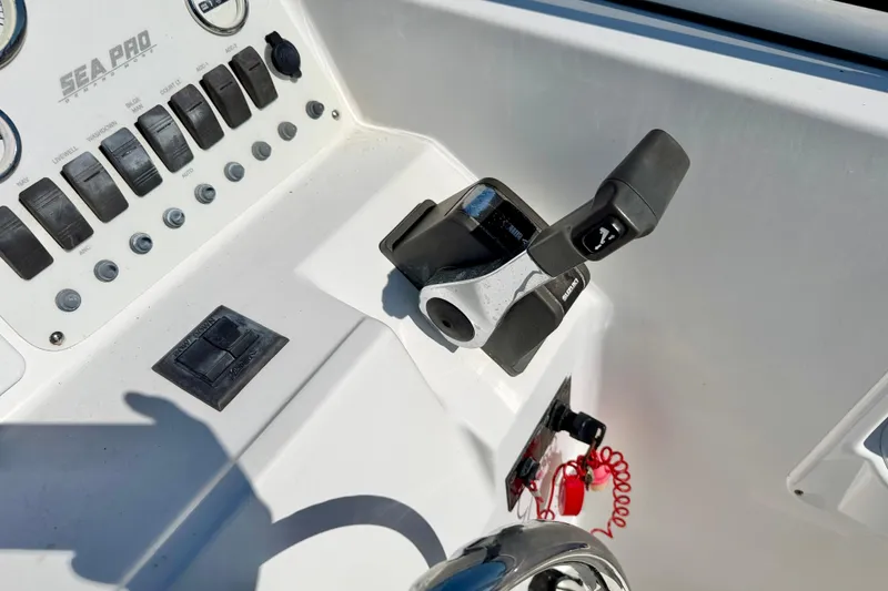 Slide: The Image of 2005 Sea Pro 220 Walk Around boat dashboard with controls and throttle lever. - 23