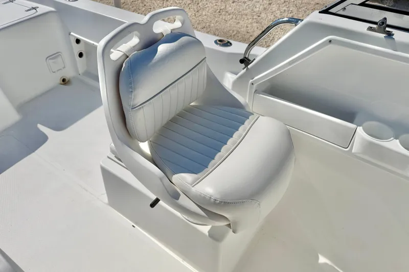Slide: The Image of 2005 Sea Pro 220 Walk Around boat seat, white upholstery, sleek design. - 26