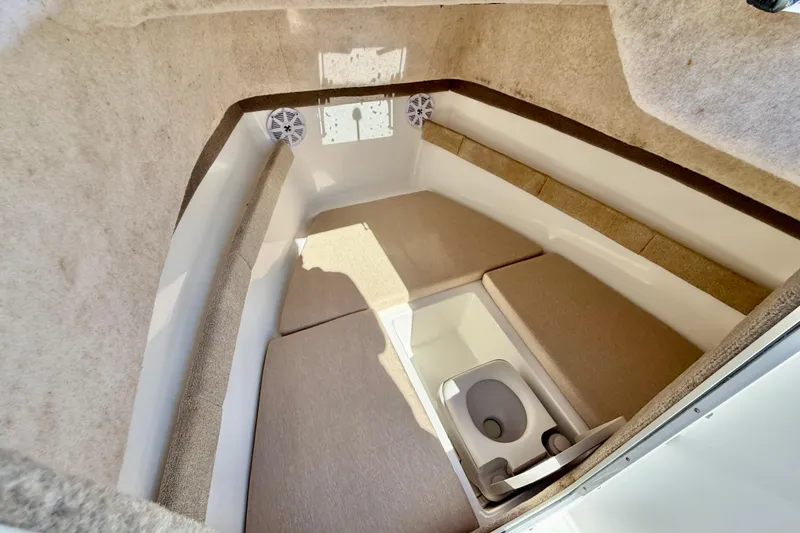 Slide: The Image of 2005 Sea Pro 220 Walk Around cabin interior with seating and portable toilet. - 30