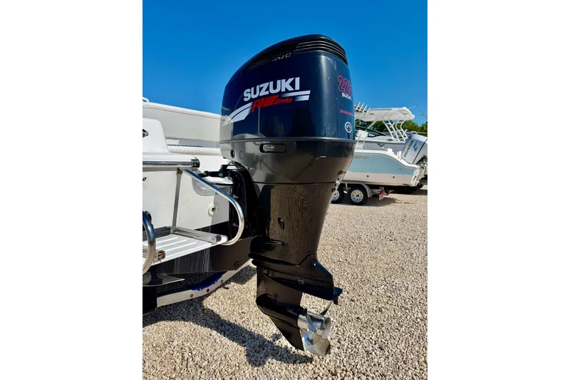 Slide: The Image of 2005 Sea Pro 220 Walk Around with Suzuki 225 outboard motor, parked on gravel. - 34