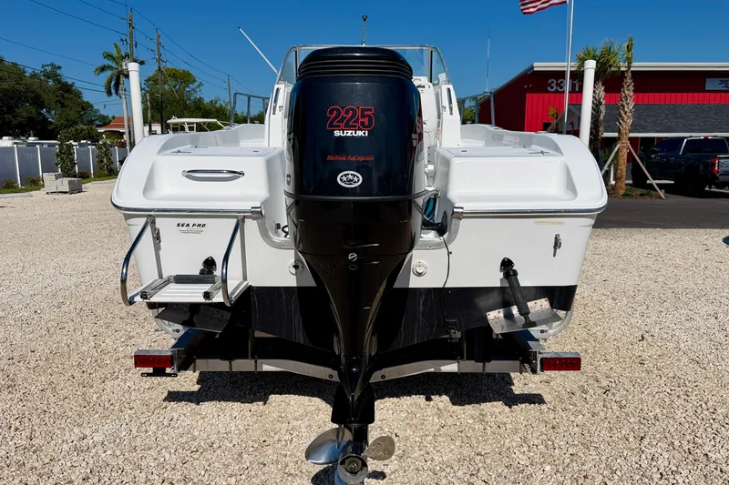 Slide: The Image of 2005 Sea Pro 220 Walk Around boat with Suzuki 225 engine, parked on gravel. - 6