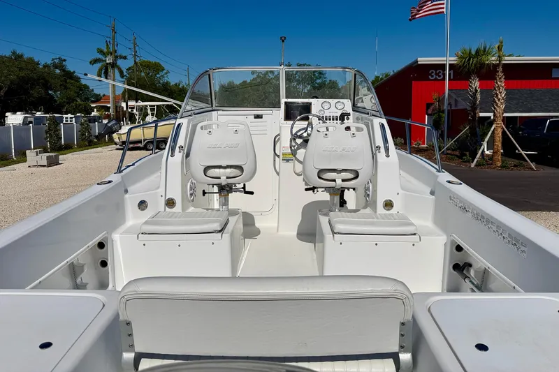 Slide: The Image of 2005 Sea Pro 220 Walk Around boat interior with dual seats and steering console. - 8