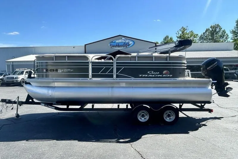 The Image of 2021 Sun Tracker Party Barge 20 DLX pontoon boat on trailer, parked outdoors. - 1