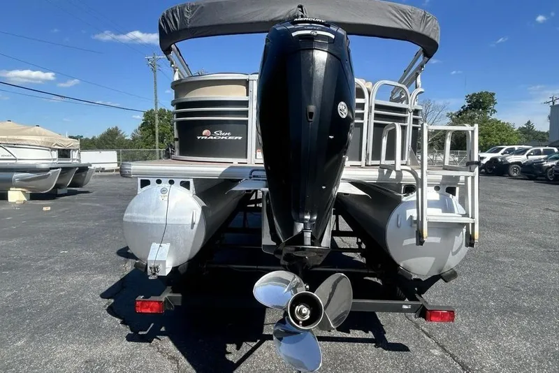 Slide: The Image of 2021 Sun Tracker Party Barge 20 DLX pontoon boat with outboard motor, parked outdoors. - 14
