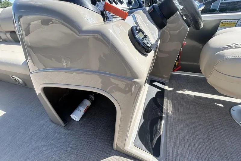 Slide: The Image of 2021 Sun Tracker Party Barge 20 DLX console with steering wheel and storage compartment. - 15