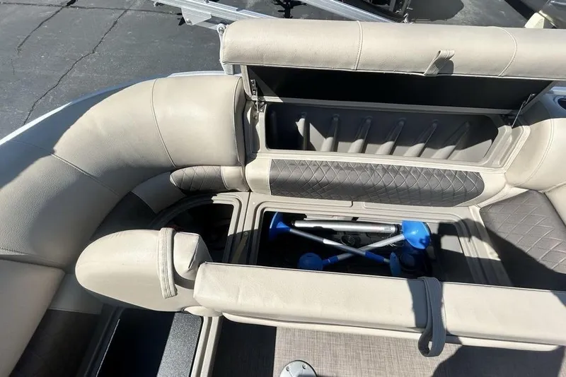 Slide: The Image of 2021 Sun Tracker Party Barge 20 DLX interior storage compartments with seating. - 16