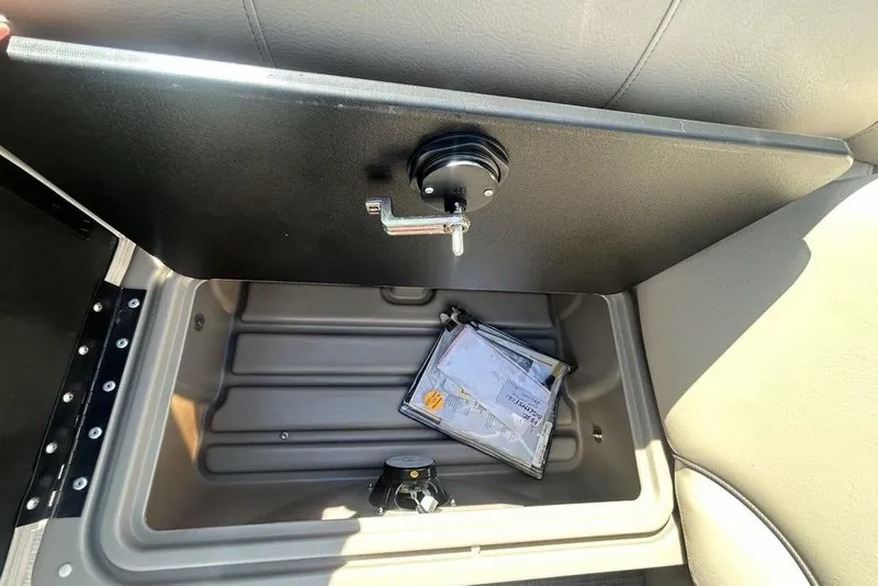 Slide: The Image of Storage compartment in a 2021 Sun Tracker Party Barge 20 DLX with documents inside. - 18