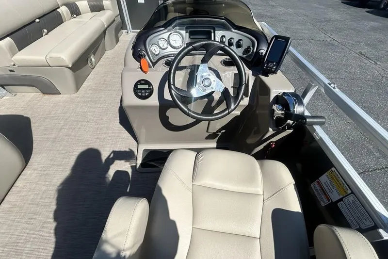 Slide: The Image of 2021 Sun Tracker Party Barge 20 DLX interior with steering console and seating. - 19