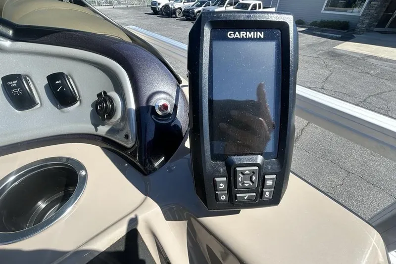 Slide: The Image of Garmin device on 2021 Sun Tracker Party Barge 20 DLX dashboard, featuring control switches. - 20