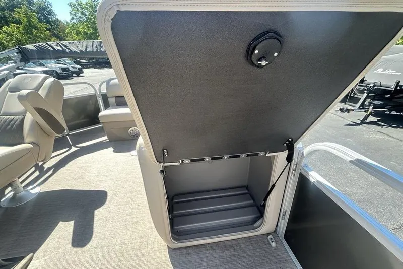 Slide: The Image of 2021 Sun Tracker Party Barge 20 DLX interior storage compartment open on deck. - 23