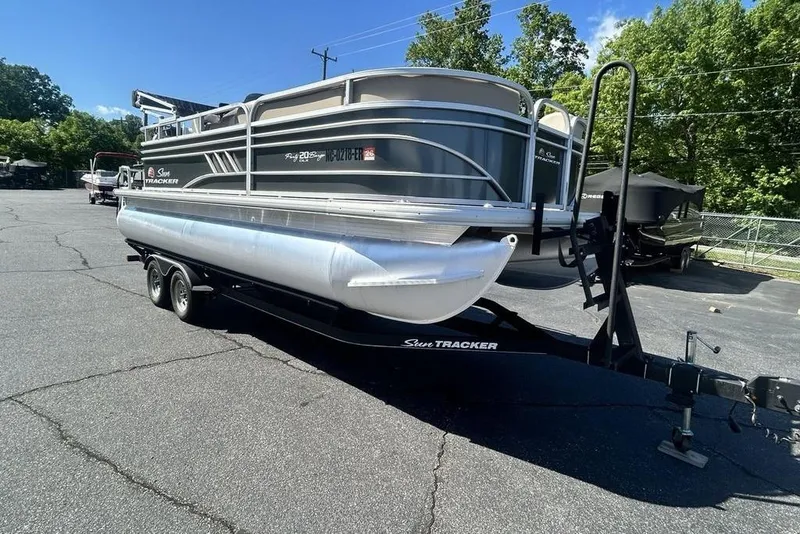 Slide: The Image of 2021 Sun Tracker Party Barge 20 DLX pontoon boat on trailer in parking lot. - 3