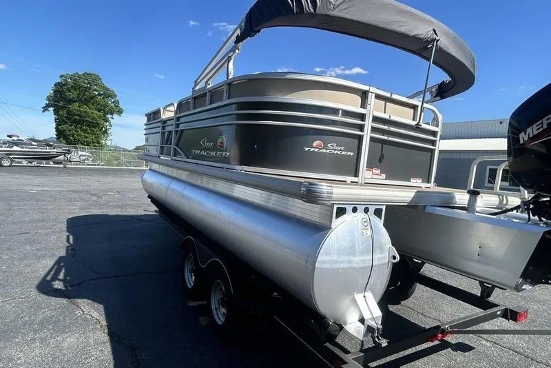 Slide: The Image of 2021 Sun Tracker Party Barge 20 DLX pontoon boat on trailer, sunny day. - 4