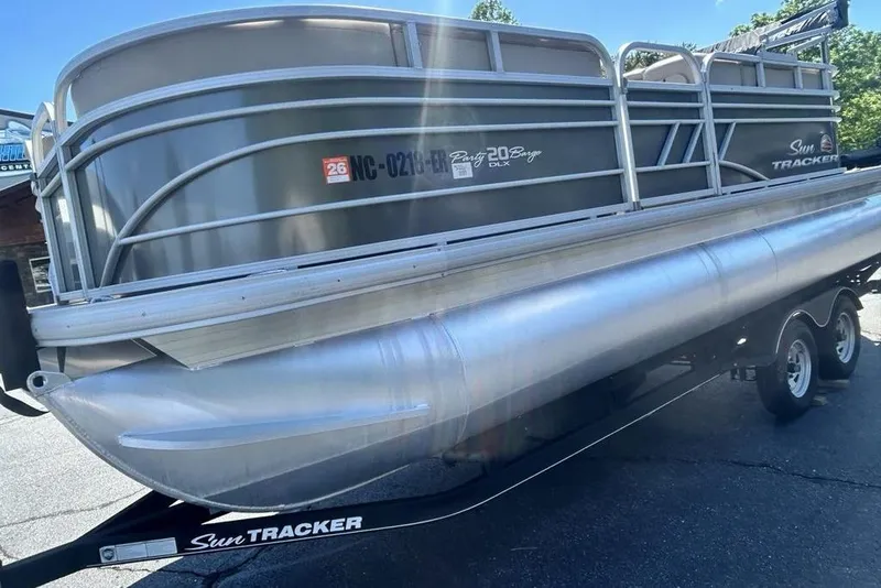 Slide: The Image of 2021 Sun Tracker Party Barge 20 DLX pontoon boat on trailer, side view. - 8