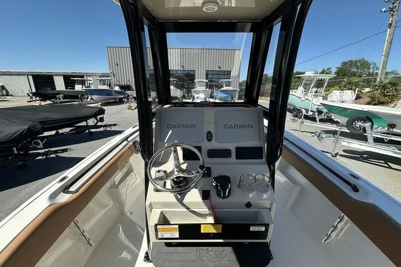 Slide: The Image of 2026 Key West 239 FSR boat console with Garmin navigation systems, parked outdoors. - 10