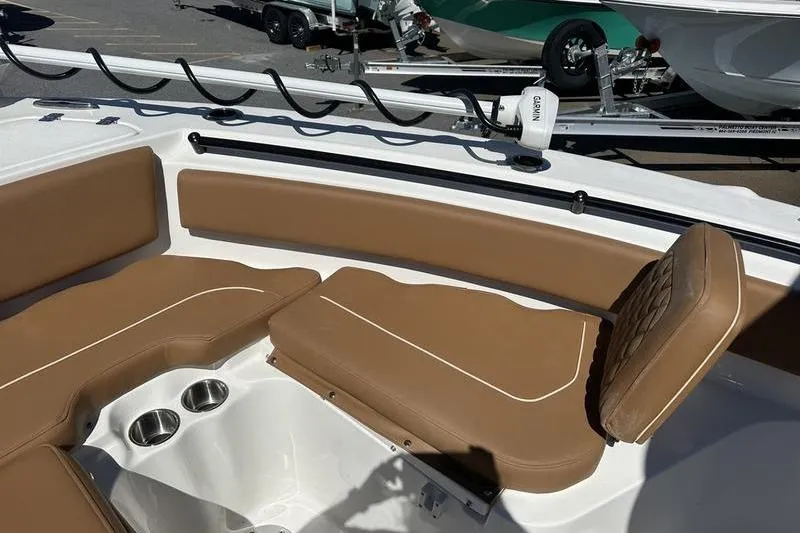 Slide: The Image of 2026 Key West 239 FSR boat interior with tan seating and cup holders. - 11