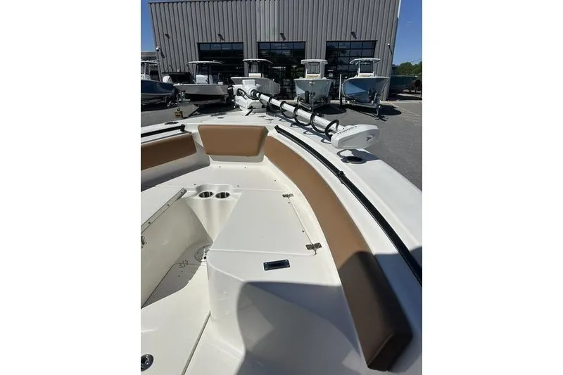 Slide: The Image of 2026 Key West 239 FSR boat interior with seating and cup holders, docked outdoors. - 13