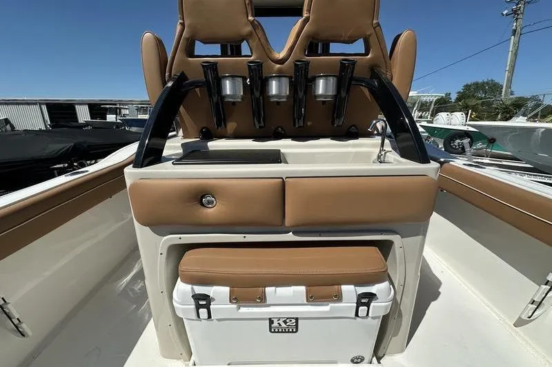 Slide: The Image of 2026 Key West 239 FSR boat interior with tan seating and K2 cooler. - 14