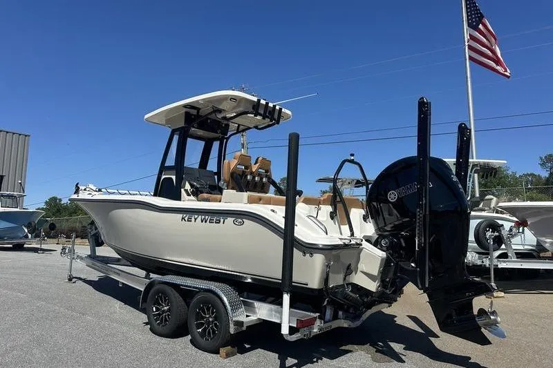 Slide: The Image of 2026 Key West 239 FSR boat on trailer, displayed outdoors under clear blue sky. - 17