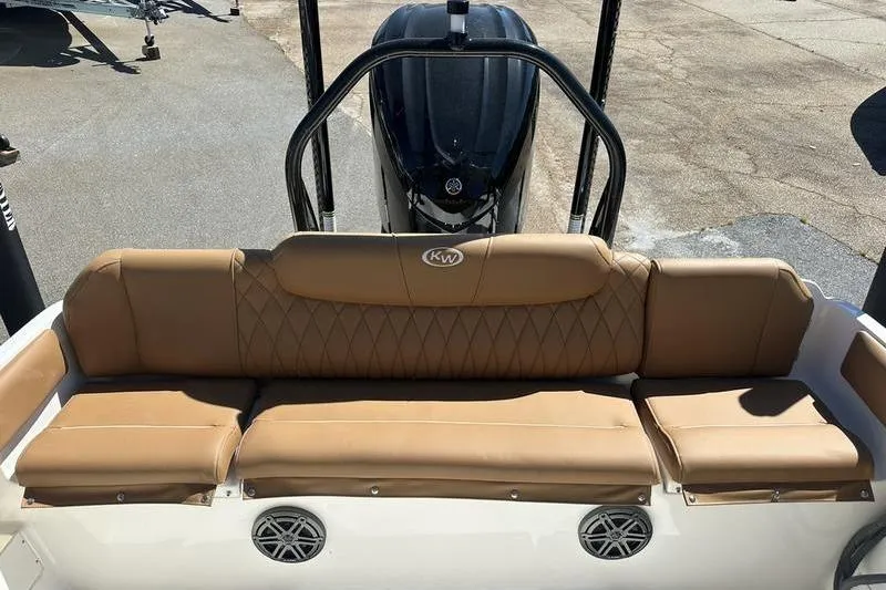 Slide: The Image of 2026 Key West 239 FSR boat with tan seating and visible engine. - 20