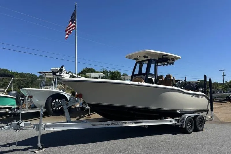 Slide: The Image of 2026 Key West 239 FSR boat on trailer with American flag in background. - 5