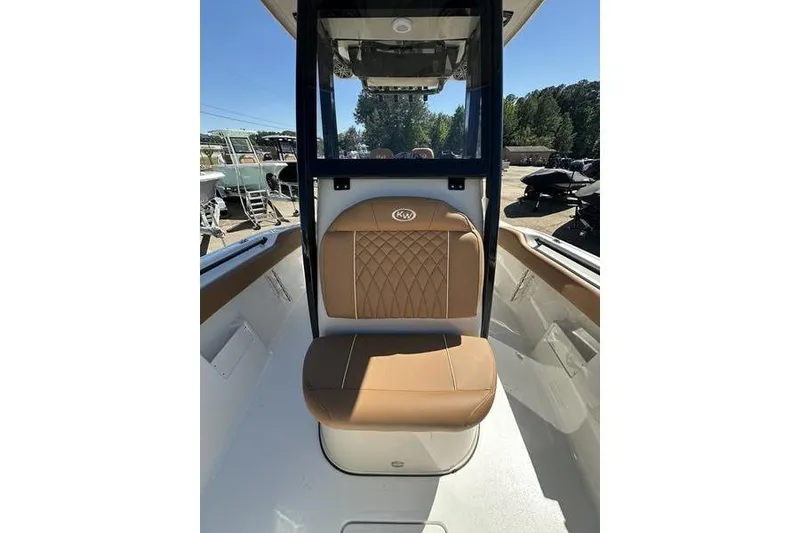 Slide: The Image of 2026 Key West 239 FSR boat interior with tan cushioned seating and sleek design. - 8