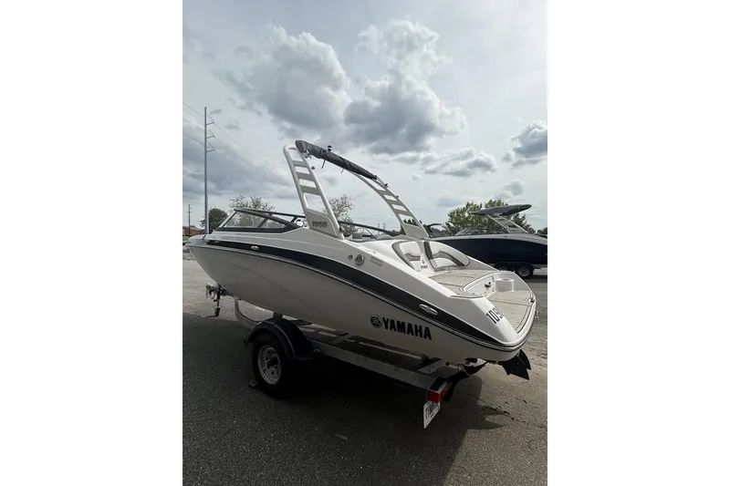 Slide: The Image of 2025 Yamaha Boats 195S on trailer under cloudy sky, showcasing sleek design. - 3