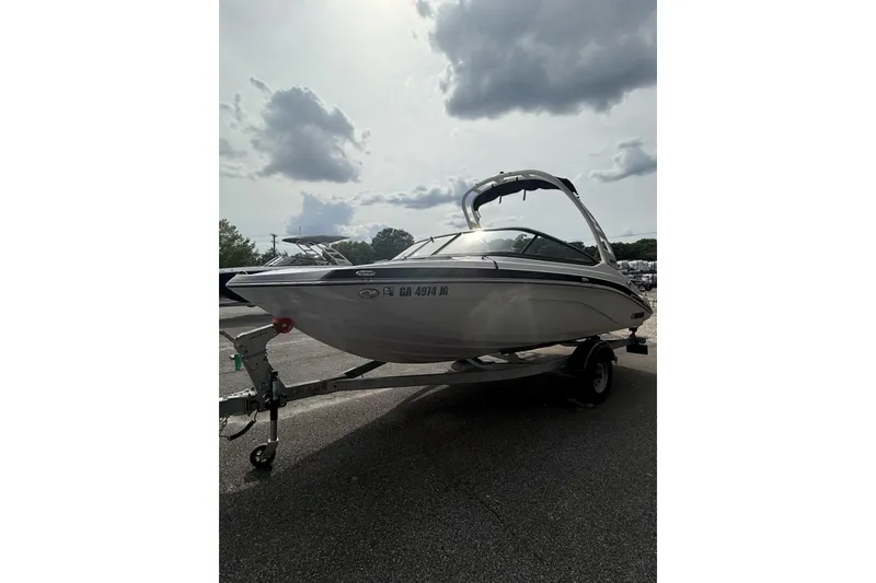 Slide: The Image of 2025 Yamaha Boats 195S on trailer under cloudy sky. - 4