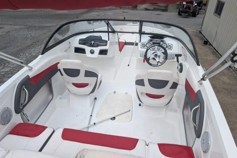 Slide: The Image of 2019 Tahoe 500 TF boat interior with red and white seating, steering wheel, and dashboard. - 5