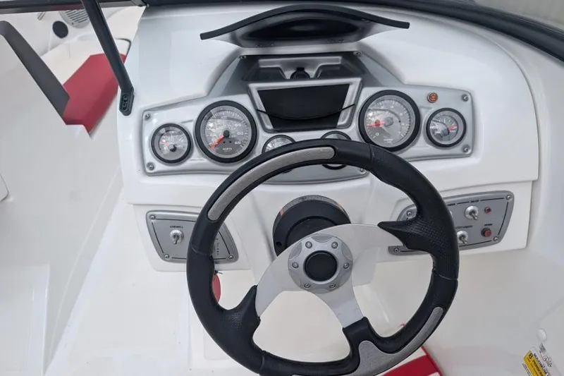 Slide: The Image of Steering wheel and dashboard of a 2019 Tahoe 500 TF boat, featuring gauges and controls. - 8