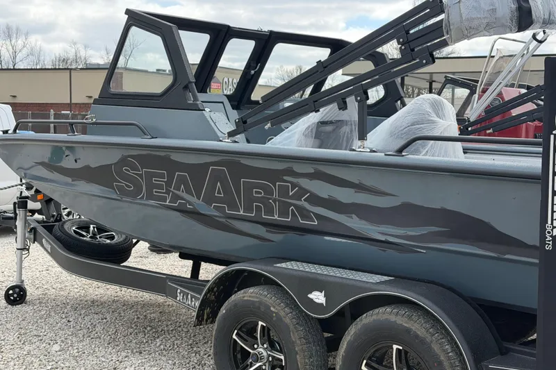 Slide: The Image of 2026 SeaArk ProCat 200 boat on trailer, gray with bold logo, parked outdoors. - 2